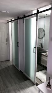 a room with two sliding glass doors and a bathroom at Charming Loft steps from the Angel in Cedro +32 photos