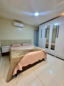 a bedroom with a large bed and a mirror at Casa Parque nacional Serra da capivara in Coronel José Diaz