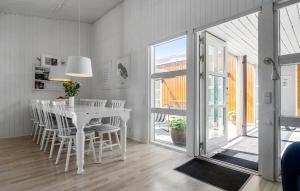a white dining room with a white table and chairs at Gorgeous Home In Sydals With Sauna in Neder Lysabild
