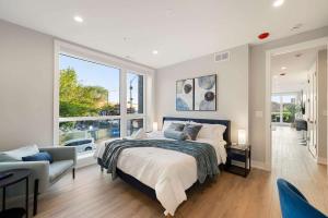 a bedroom with a large bed and a large window at New Build in Pilsen Spacious 2 Bed 2 Bath Unit in Chicago