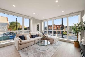 a living room with a couch and a glass table at New Build in Pilsen Spacious 2 Bed 2 Bath Unit in Chicago