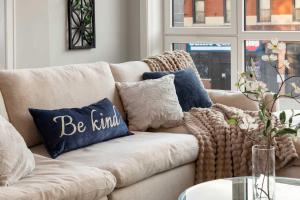 a couch with pillows on it in a living room at New Build in Pilsen Spacious 2 Bed 2 Bath Unit in Chicago
