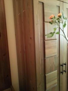 a vase with a flower is next to a door at Sea View Family Hotel in Kranevo +45 photos