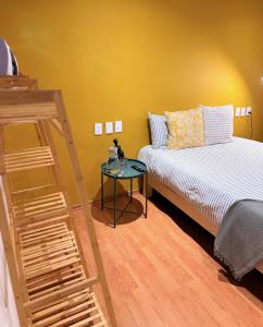 a bedroom with a bed and a glass table at Private room La Americana Chapultepec in Guadalajara