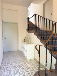 a hallway with a spiral staircase and a door at Private room La Americana Chapultepec in Guadalajara