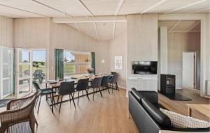 a dining room with a table and chairs at Strandblick 27 in Schönhagen