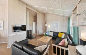a living room with a couch and a tv at Strandblick 27 in Schönhagen