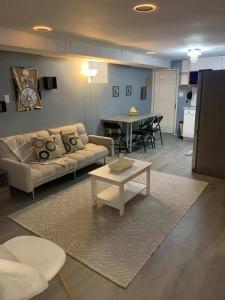 a living room with a couch and a table at Suhira Hospitality in Lansdowne