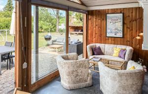 a living room with a couch and chairs and a patio at Gorgeous Home In Gilleleje With Wifi in Gilleleje