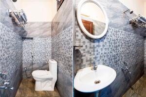 a bathroom with a sink and a toilet and a mirror at Hotel O Tirumala Road Near Alipiri in Tirupati