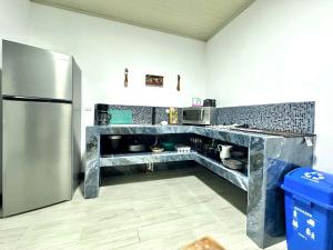 a kitchen with a stainless steel refrigerator at En-suite Paraiso #1 in Parrita