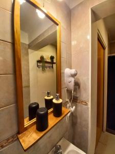a bathroom with a mirror and a sink at Departamento Mamá Inés in Esquel +20 photos