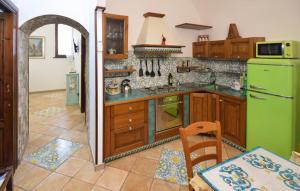 a kitchen with wooden cabinets and a green refrigerator at 1 Bedroom Nice Apartment In Molina in Marina +11 photos