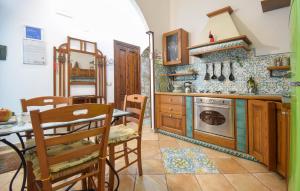 a kitchen with a table and a table and chairs at 1 Bedroom Nice Apartment In Molina in Marina