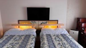Ένα ή περισσότερα κρεβάτια σε δωμάτιο στο Kyoto Aya Guest House