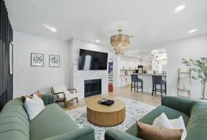 a living room with a couch and a table at The Beach Oasis In Dallas, Pool & Sauna in Plano