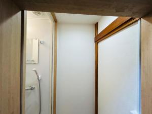 a bathroom with a shower and a glass door at 池袋House3F Cozy for 1-3 guests in Tokyo +16 photos
