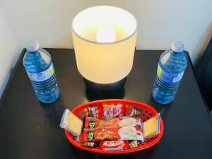 a table with a basket of food and two bottles of water at Rm2 - Bright and Gorgeous in Mississauga