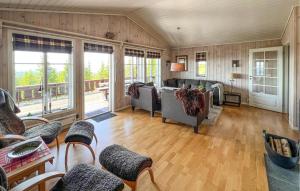 a living room with couches and a table and chairs at Gorgeous Home In Sjusjøen With Sauna in Sjusjøen
