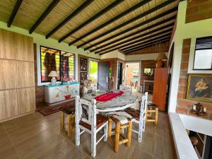 a dining room with a table and chairs at Casa de Campo en San Pedro in San Pedro +9 photos