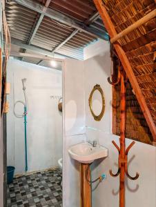 a bathroom with a sink and a shower at Yellow Sun Kampot in Kampot