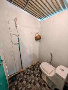 a bathroom with a toilet and a shower at Yellow Sun Kampot in Kampot