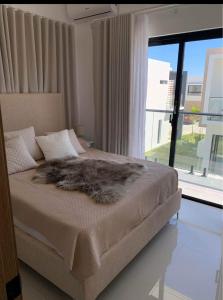 a bedroom with a bed with a furry blanket on it at Villa Familiar con Piscina en VistaCana in Punta Cana