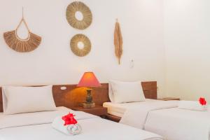 Postel nebo postele na pokoji v ubytování Bramasa Ubud Guest House