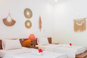 Postel nebo postele na pokoji v ubytování Bramasa Ubud Guest House