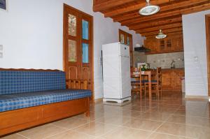 a living room with a refrigerator and a kitchen at Athina Studios in Symi