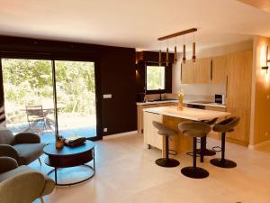 a kitchen with a island and chairs in a room at Villa La perle des Sylves in Neufchâtel-Hardelot