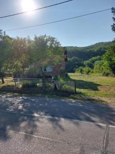 a house with a fence on the side of a road at Camping Nori-Una in Hrvatska Kostajnica