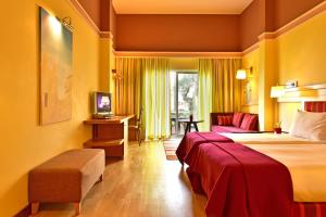 a hotel room with a large bed and a chair at Pestana Sintra Golf Resort & SPA Hotel in Sintra