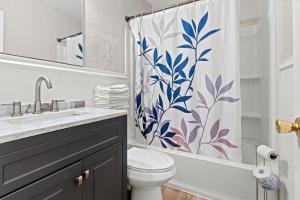 a bathroom with a toilet and a shower curtain at Shore Oasis in Seaside Heights +52 photos