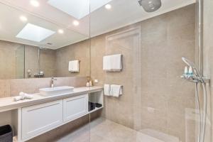 a bathroom with a sink and a shower at Mirage Resort Villa 432 with access to Sheraton Facilities in Port Douglas