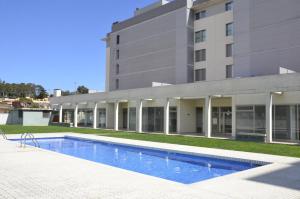 a swimming pool in front of a building at AB Sant Antoni de Calonge in Calonge