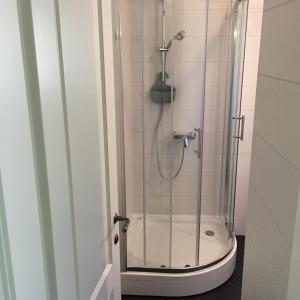 a bathroom with a shower with a glass door at Apartments Seaside Baosici in Herceg-Novi