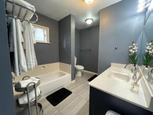 a bathroom with a tub and a sink and a toilet at Lovely Home 30MIN to Berkeley, SF, Napa in Pinole +27 photos