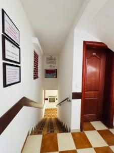 a hallway with a stairway with a door and a floor at Apartments TRI SRCA in Sutomore