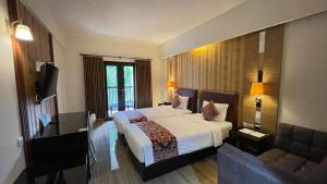 Postel nebo postele na pokoji v ubytování The Tandibayang Hotel & Villas