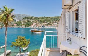 einen Balkon mit einem Tisch und einem Boot im Wasser in der Unterkunft Apartments Marija Lapad in Dubrovnik