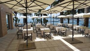 a restaurant with tables and chairs under umbrellas at Hotel Continental in Santa Margherita Ligure