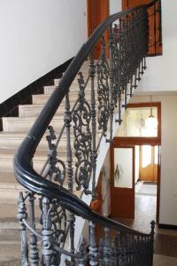 a staircase with a spiralsteel railing in a house at Residence Bílkova in Prague