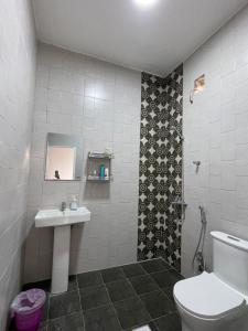 a bathroom with a toilet and a sink at Samail Valley in Samail