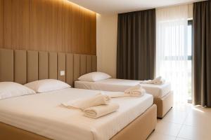Postel nebo postele na pokoji v ubytování Velmar Hotel