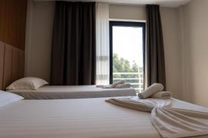 Postel nebo postele na pokoji v ubytování Velmar Hotel