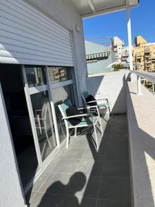 a shadow of a person on a balcony with a table and chairs at דירה בוטיק in Rishon LeẔiyyon