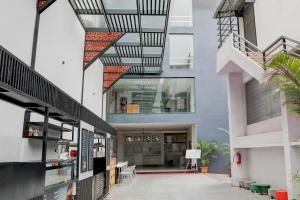 an external view of a building with a spiral staircase at Super Townhouse Shivamogga Formerly Karthik Bhavan in Shimoga