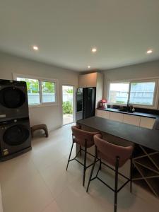 a kitchen with a table and chairs in a room at Supalai Rent BANG TAO PHUKET in Phuket +18 photos