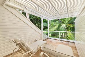 an empty porch with two chairs and a window at Mirage Resort Villa 428 with access to Sheraton Facilities in Port Douglas